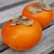 Two orange persimmon kaki fruits