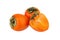 Two orange persimmons fruits or diospyros and one cut off half of persimmon with green leaves on white background isolated closeup