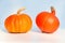 Two orange pumpkins, different varieties