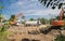 Two orange tracked excavators and a gray dump truck in process of excavation