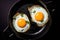 Two Organic Fried Eggs Seasoned with Herbs in a Black Cast-iron Skillet Top Down View