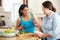 Two Overweight Women On Diet Preparing Vegetables in Kitchen