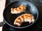 Two Oxtails tails of cattle fried in pan at home