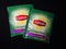 Two packets of Lipton Green tea Tulsi natural on dark background