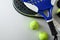 Two paddle tennis rackets and set of balls top view