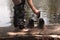 Two pair of boys shoes standing on the stone of a lake while they are having fun swimming