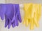 Two pair of rubber gloves hanging on a white basket for housekeeping cleaning equipments