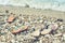 Two pair of slippers on the beach on the cobblestones against the waves by the sea. Toned