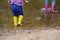 Two pairs of color children`s gumboots standing children