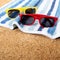 Two pairs couple sunglasses beach towel sand background