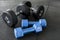 Two pairs of dumbbells of different types - One cast iron and coated with rubber, the other made of hard plastic.