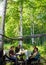 Two pairs of elderly Yakuts sit at a table with food in a place to rest in the wild taiga of the birch forest