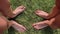 Two pairs of female feet stand opposite each other on the green grass