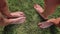 Two pairs of female feet stand opposite each other on the green grass