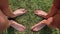 Two pairs of female feet stand opposite each other on the green grass
