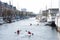 Two pairs of kayaks are sailing down a European river