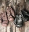 two pairs of leather vintage boxing gloves hanging on a nail