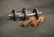 Two pairs of old dumbbells lie on the floor on a sports field on the street