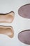 Two pairs orthopedic shoe insoles isolated on beige background