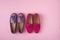 Two pairs of suede moccasins shoes lilac and bright raspberry over pink background