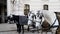 Two pairs of white and black beautiful horses with carriage in Vienna historical city center near Hofburg palace