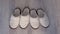 Two pairs of white slippers from sheep wool, closeup view.