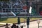 Two Pakistani men wave flags and hype up the crowd for the Wagah Border Closing Ceremony with