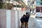 Two Pakistani school kids walking along the boundary wall and fence