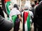 Two Palestinian protesters cover up themselves with Palestine flag at Sydney Townhall.