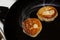 Two Pancakes fried in a frying pan closeup