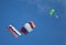 Two parachutists gliding with russian flags on blue sky background