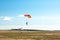 Two parachutists are landing on colorful parachutes to aerodrome