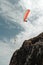 two paragliders gliding over a cliff