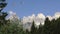 Two paraglides flying on Dolomiti mountains and woods
