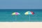 Two parasols on the beach.Multicolored umbrellas on a white sand.Tropical paradise