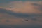 Two passenger jets passing by through cloudy skies