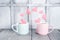 Two pastel cups with flying marshmallow hearts