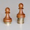 Two pawns chess pieces on columns of coins, symbolizing significant income inequality