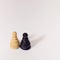 Two pawns of wooden chess figures on a white background. Minimal design