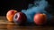 two peaches and an apple on a table with smoke coming out of the top of them and a blue cloud of smoke behind them