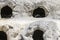 Two penguins sleeping inside their cave colony in the rocks