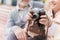 Two pensioners are sitting on the bench and studying a vintage camera. They are going to take a few photos