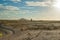 Two people in distance standing looking across expansive beach landscape