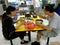 Two people eat at a typical Singapore food court or Hawker