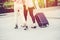 Two people friend tourist girl with traveller luggage walking