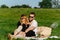 Two people having a picnic in a countryside on a green grass