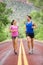 Two people jogging for fitness running on road