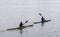 Two people kayak on the calm waters