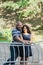 Two people in love are standing at the idle fountain in the park.