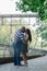 Two people in love are standing at the idle fountain in the park.